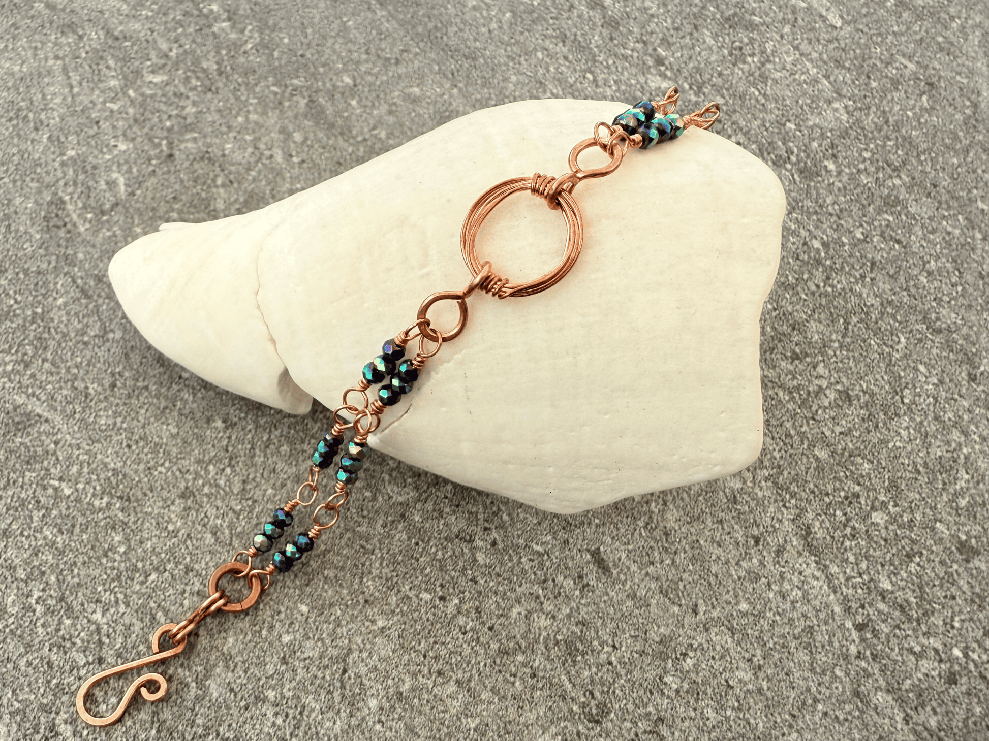 view of bracelet displayed on a white shell