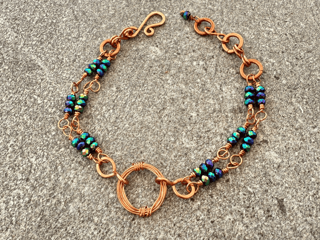 Crystal peacock crystal bracelet displayed on a slate background