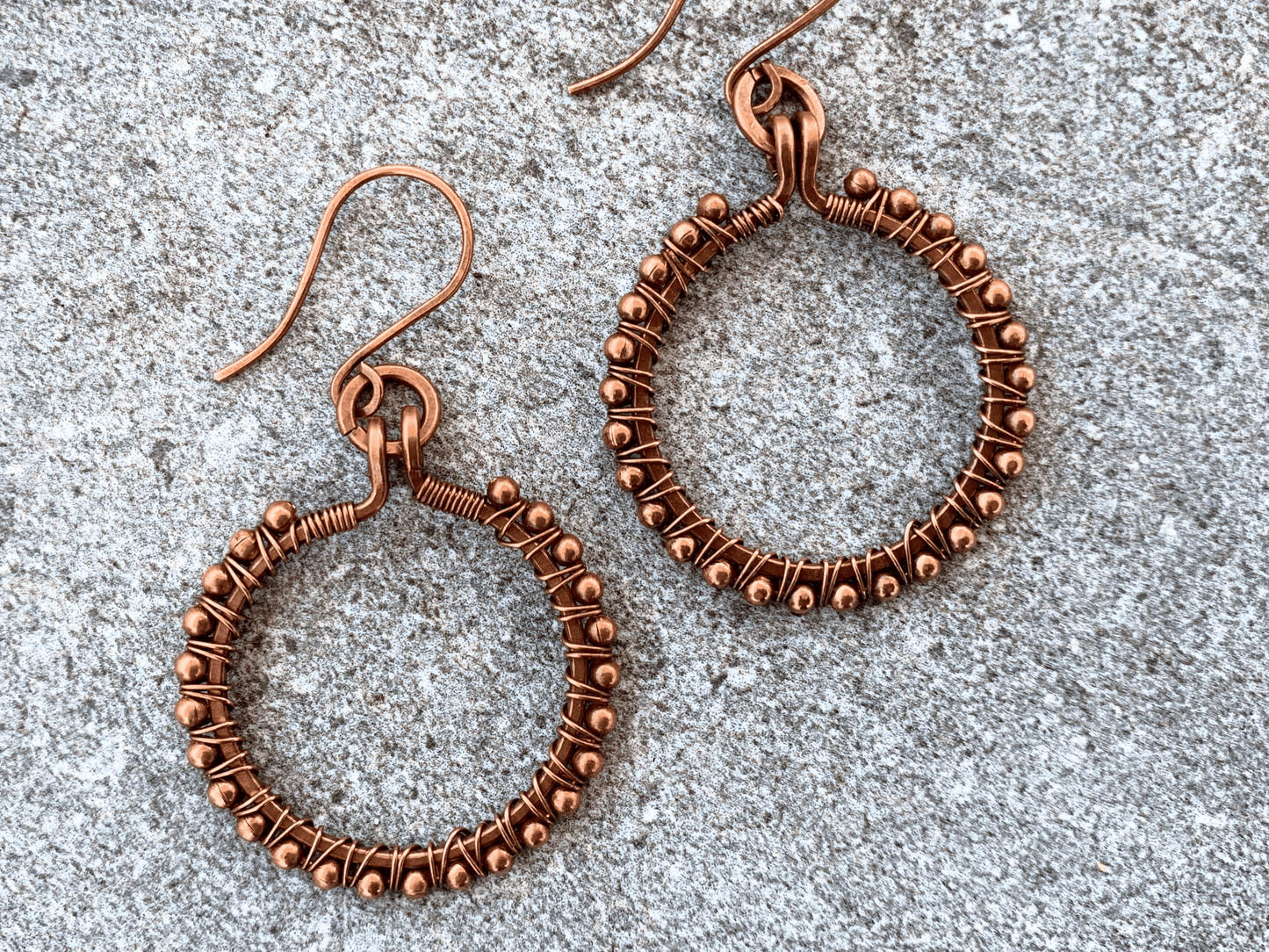 Hoop earrings from above on concrete